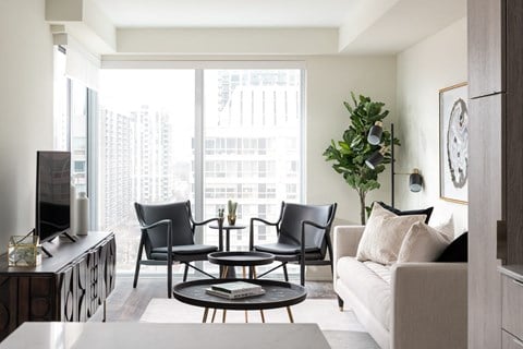 a living room with a couch and chairs and a television